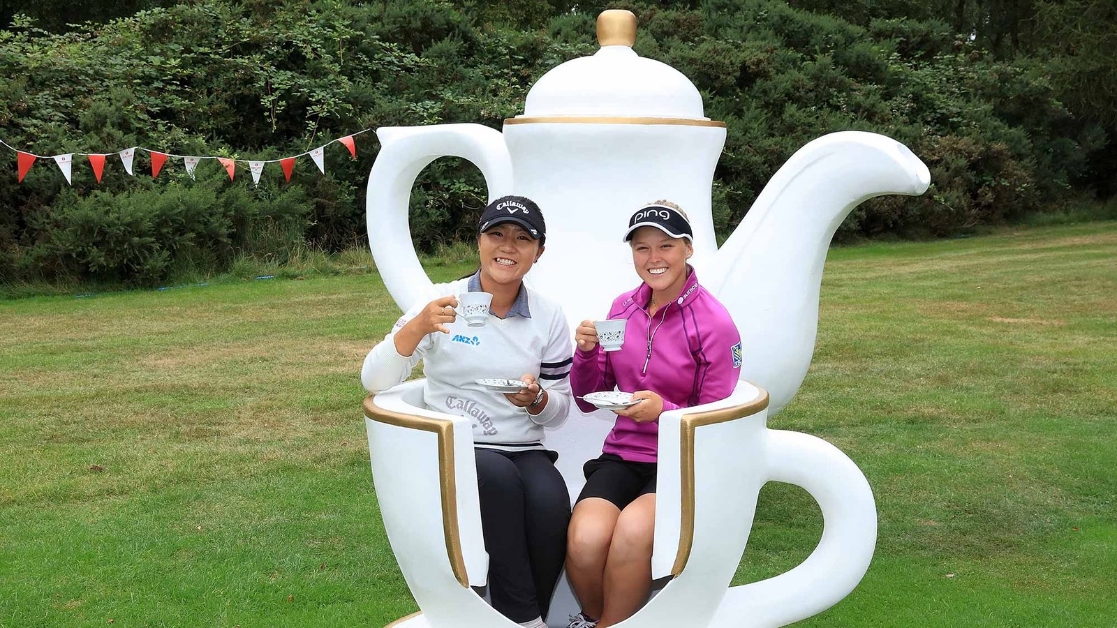 Lydia Ko and Brooke Henderson have tea at a party hosted by Charley Hull during the Pro-Am