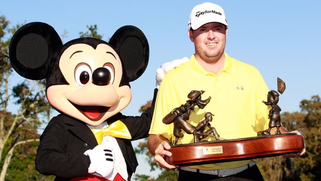 Mickey presentss Robert Garrigus the Children's Miracle Network Classic trophy