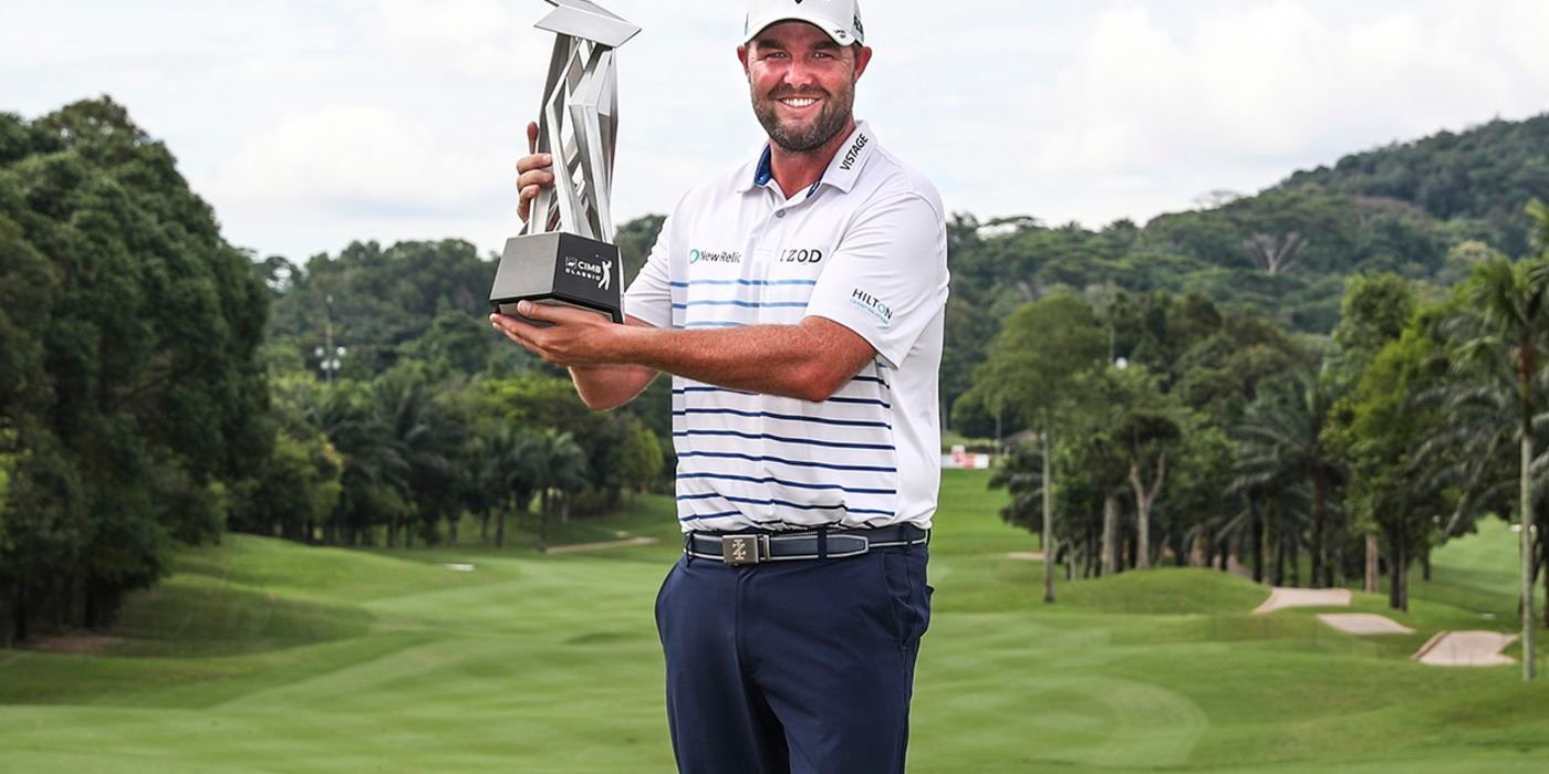 Marc Leishman hoists the CIMB trophy