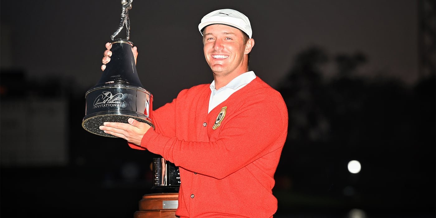 Bryson DeChambeau with API trophy and red cardigan