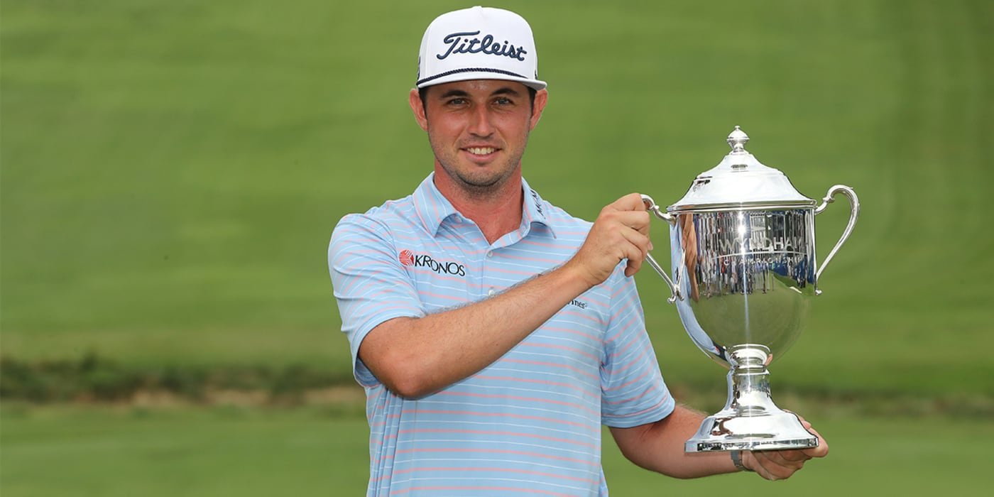 J.T. Poston hoists the Wyndham trophy
