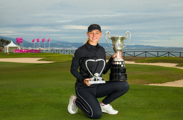 Emily Pedersen with the Open de Espana and Race to Costa del Sol trophies
