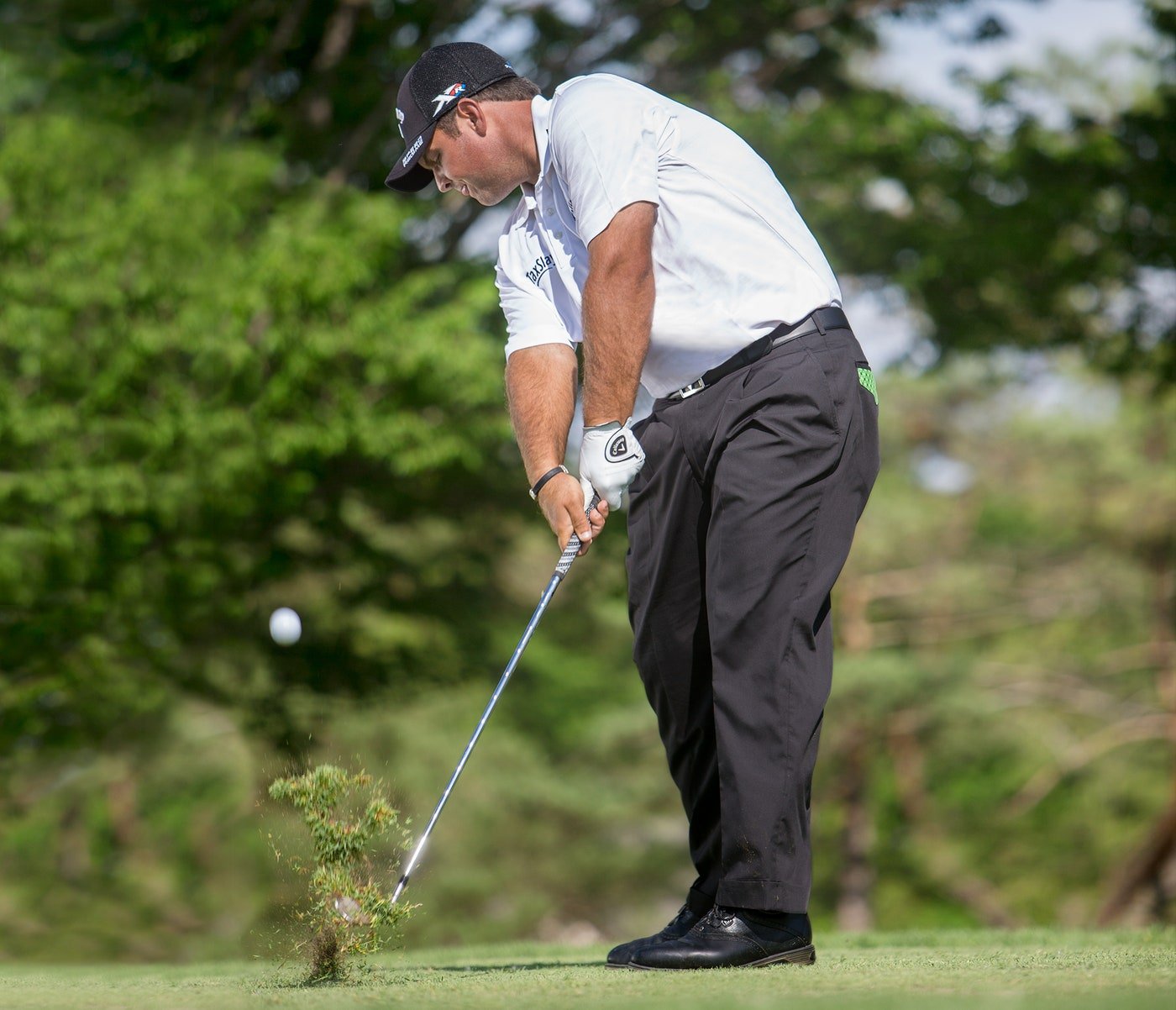 Patrick Reed taking a divot